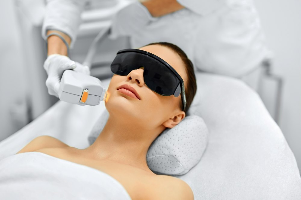 a lady is undertaking laser hair removal treatment
